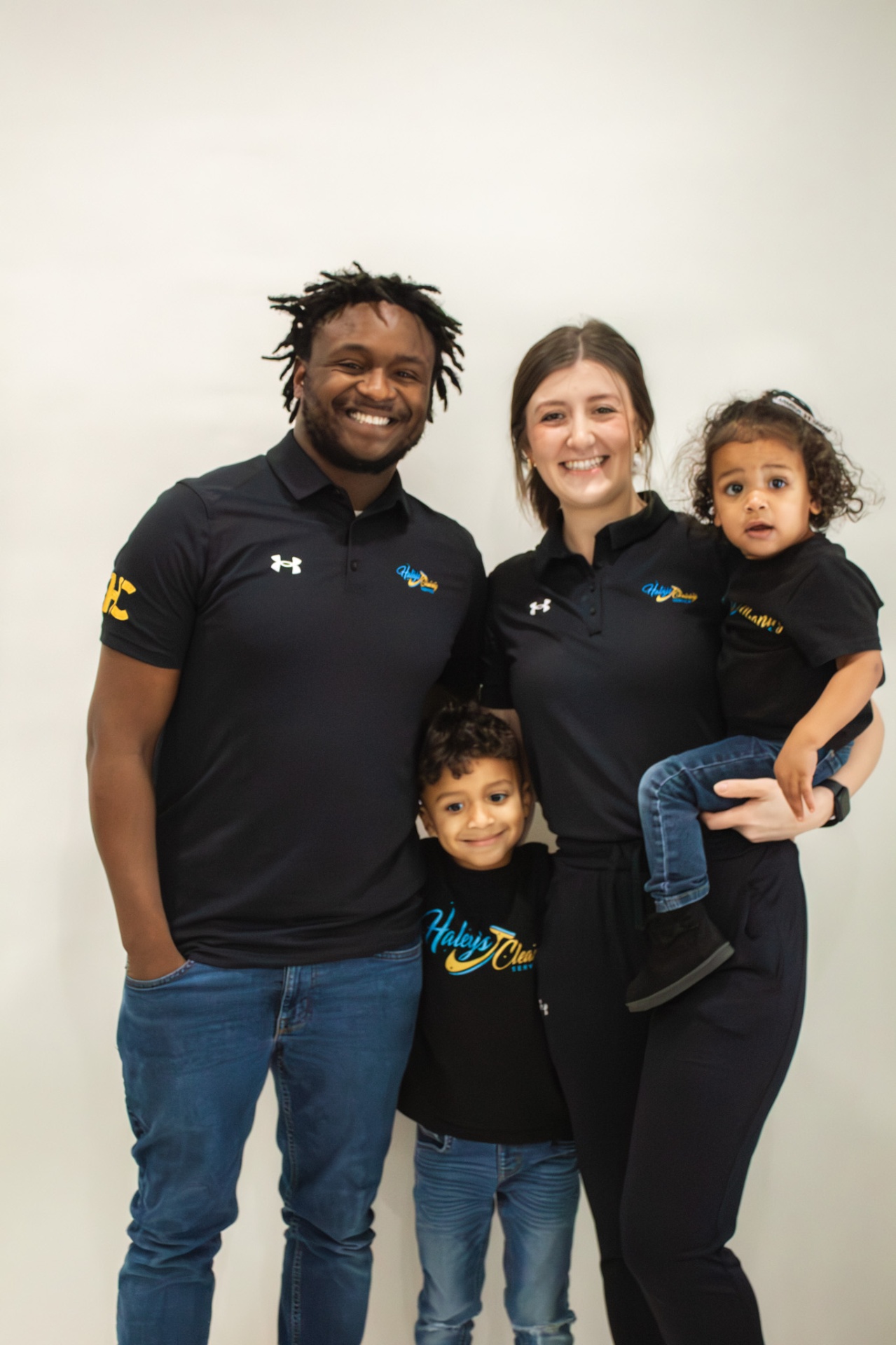 The Haley's Cleaning Service family — founders and their kids in branded polos